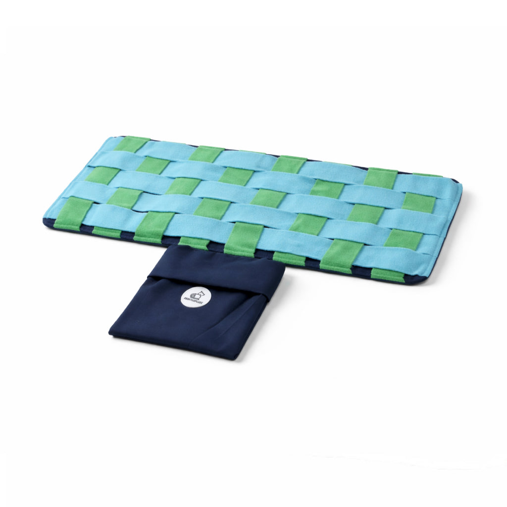 Woven blue and green mat with a pouch on a white background