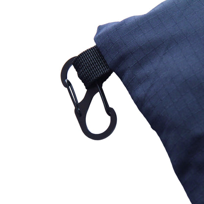 Close-up of a blue packed SnuffleMat with a black carabiner clip on a white background